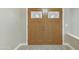 Double front doors featuring glass panes and wood construction welcome you into this home's entryway at 3907 W Sharon Ave, Phoenix, AZ 85029