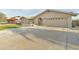 Neutral-colored single Gathering home with well-manicured turf and an attached two-car garage at 3907 W Sharon Ave, Phoenix, AZ 85029