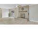 Living room with decorative fireplace and sliding glass doors to outside area at 3907 W Sharon Ave, Phoenix, AZ 85029