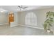 Bright living area showcasing a shuttered arched window, modern flooring, and natural light at 3907 W Sharon Ave, Phoenix, AZ 85029