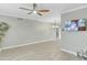 Large living area featuring sleek ceiling fan, surveillance system and updated flooring at 3907 W Sharon Ave, Phoenix, AZ 85029