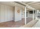 Covered patio area with tiled flooring, decorative sun ornament, and backyard access at 3907 W Sharon Ave, Phoenix, AZ 85029