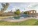 Swimming pool with diving board surrounded by lush landscaping and a shaded pergola at 3907 W Sharon Ave, Phoenix, AZ 85029