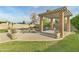 Inviting pool area with a covered patio, lush lawn, and privacy fencing at 3907 W Sharon Ave, Phoenix, AZ 85029
