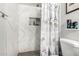 Updated bathroom featuring a marble tiled shower with built-in niche and gray fixtures at 5422 E Des Moines St, Mesa, AZ 85205