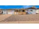 Charming one-story house with xeriscaped front yard, decorative wood accents, and attached garage at 5422 E Des Moines St, Mesa, AZ 85205