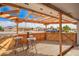 Cozy outdoor patio with wood floors and pergola roof, perfect for relaxing or entertaining guests at 5422 E Des Moines St, Mesa, AZ 85205