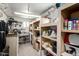 Functional workshop with shelving, pegboard, work bench, and plenty of room for storage at 5422 E Des Moines St, Mesa, AZ 85205