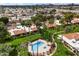 Overhead shot of community pool area surrounded by green grass and palm trees at 5465 N 78Th St, Scottsdale, AZ 85250
