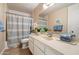 Bathroom with a vanity, mirror, and shower with blue accents at 5465 N 78Th St, Scottsdale, AZ 85250