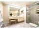 Bright bathroom featuring a glass-enclosed shower, vanity, and a large mirror at 5465 N 78Th St, Scottsdale, AZ 85250