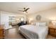 Bright, spacious bedroom featuring a plush king bed, ceiling fan, and mirrored closet at 5465 N 78Th St, Scottsdale, AZ 85250
