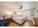Serene bedroom featuring a comfortable king bed, modern ceiling fan, and bright natural light at 5465 N 78Th St, Scottsdale, AZ 85250