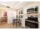Cozy eat-in kitchen features modern stainless steel appliances and a quaint breakfast table at 5465 N 78Th St, Scottsdale, AZ 85250