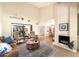 Bright living room with high ceilings, a fireplace, wood-look floors, and neutral tones at 5465 N 78Th St, Scottsdale, AZ 85250