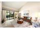 Cozy living room featuring comfortable seating, a decorative rug, and sliding glass doors at 5465 N 78Th St, Scottsdale, AZ 85250