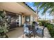 View of a covered patio with a dining table, ceiling fan, and beautiful outdoor landscaping at 5465 N 78Th St, Scottsdale, AZ 85250