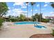 Community pool area with a hot tub, lounge chairs, umbrellas, and mature trees at 5465 N 78Th St, Scottsdale, AZ 85250