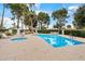 Community pool area with a hot tub and umbrellas, surrounded by lush landscaping at 5465 N 78Th St, Scottsdale, AZ 85250