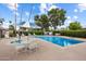 Community pool area with umbrellas, lounge chairs, and well-maintained landscaping at 5465 N 78Th St, Scottsdale, AZ 85250