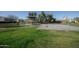 View of the community park with lush green grass, a covered picnic area, and a basketball court at 6538 W Elwood St, Phoenix, AZ 85043