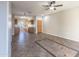 Inviting living room with tile flooring, ceiling fan, and open access to the kitchen area at 6538 W Elwood St, Phoenix, AZ 85043