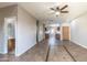 Spacious open-concept living room features tile flooring, ceiling fan, and access to the kitchen at 6538 W Elwood St, Phoenix, AZ 85043