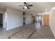 Bright, open-concept living space with tile flooring and ceiling fan seamlessly connects to the kitchen at 6538 W Elwood St, Phoenix, AZ 85043
