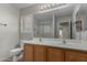 Bathroom featuring double sinks, a large mirror, and a walk-in shower at 7164 W Paso Trl, Peoria, AZ 85383