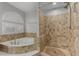 Bathroom featuring a separate tub, walk in shower, and tiled walls at 7164 W Paso Trl, Peoria, AZ 85383