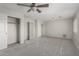 Spacious bedroom featuring gray carpet and a ceiling fan, offering a cozy space at 7164 W Paso Trl, Peoria, AZ 85383