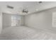 Spacious carpeted bedroom with sliding glass doors to the backyard at 7164 W Paso Trl, Peoria, AZ 85383