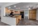 Well-lit kitchen features stainless appliances, granite countertops, and a breakfast bar at 7164 W Paso Trl, Peoria, AZ 85383
