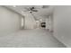 Spacious living room featuring gray carpet and a ceiling fan, offering a cozy space at 7164 W Paso Trl, Peoria, AZ 85383