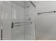 Shower featuring a glass door and tile walls at 7164 W Paso Trl, Peoria, AZ 85383