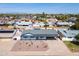 This aerial shows a charming home with desert landscaping, a covered carport, and a serene neighborhood setting at 7346 E Mckinley St, Scottsdale, AZ 85257
