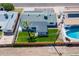 Aerial view showcasing backyard with lush lawn, mature palm tree, and private pool at 7346 E Mckinley St, Scottsdale, AZ 85257