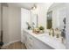 Elegant bathroom featuring double sinks with gold fixtures and quartz countertop at 7346 E Mckinley St, Scottsdale, AZ 85257