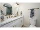 Bright bathroom with a double vanity, white marble countertop, and gold fixtures, offering a modern, clean aesthetic at 7346 E Mckinley St, Scottsdale, AZ 85257