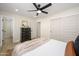 Bright bedroom with a ceiling fan, black dresser, and lots of closet space at 7346 E Mckinley St, Scottsdale, AZ 85257
