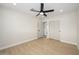 Bright bedroom features light wood-look floors, a ceiling fan, neutral walls, and a closet for storage at 7346 E Mckinley St, Scottsdale, AZ 85257