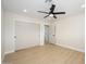 Spacious bedroom boasts light wood-look flooring, a ceiling fan, closet space and an ensuite bathroom for added convenience at 7346 E Mckinley St, Scottsdale, AZ 85257