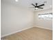 Clean, bright bedroom with light wood-look floors, a ceiling fan, neutral walls and a window offering natural light at 7346 E Mckinley St, Scottsdale, AZ 85257