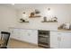 Elegant dining area features custom cabinets, built-in shelving, and a wine cooler at 7346 E Mckinley St, Scottsdale, AZ 85257