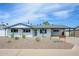Charming single-story home with a well-maintained front yard and covered parking at 7346 E Mckinley St, Scottsdale, AZ 85257