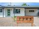A charming home with a well-manicured front yard, a modern green door, and an inviting, covered front porch at 7346 E Mckinley St, Scottsdale, AZ 85257