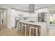 Modern kitchen features white cabinets, stainless steel appliances, and a large island with bar seating at 7346 E Mckinley St, Scottsdale, AZ 85257