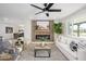 Bright living room boasts a cozy fireplace, stylish decor, and plenty of natural light at 7346 E Mckinley St, Scottsdale, AZ 85257