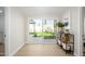 Bright living room with sliding glass doors to the backyard, light wood-look floors, and a decorative shelving unit at 7346 E Mckinley St, Scottsdale, AZ 85257