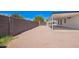 Gravel backyard with covered patio and brick privacy wall at 7707 E Garnet Ave, Mesa, AZ 85209